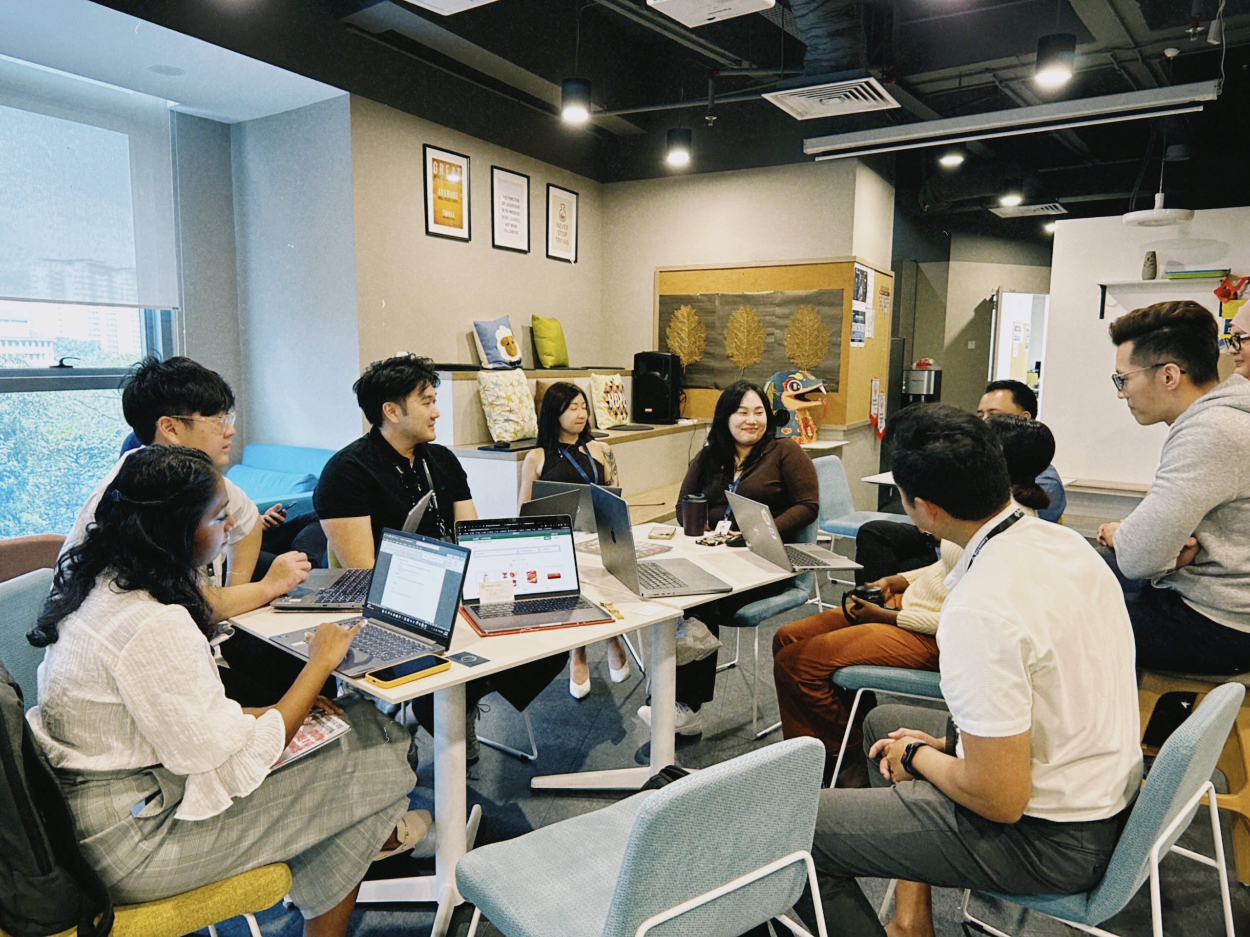 Beyonary colleagues working together around laptops